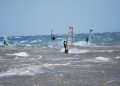 Windsurfers on a choppy Aegean shore