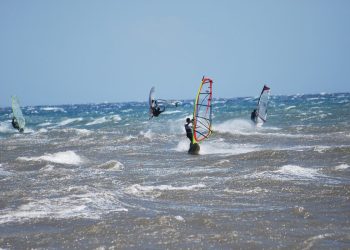 Windsurfers on a choppy Aegean shore